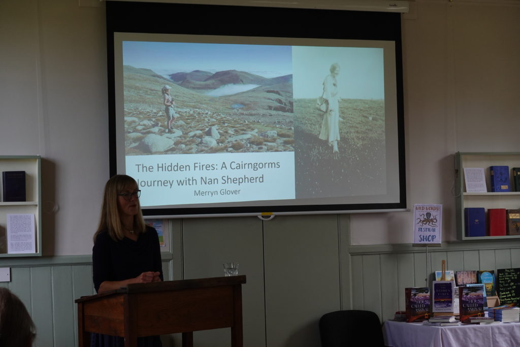 Author Merryn Glover standing in front of her powerpoint presentation.